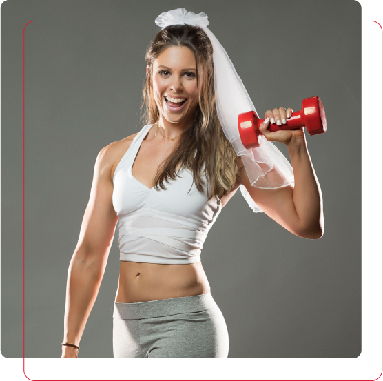 Wedding-ready bride showing fitness progress with a dumbbell